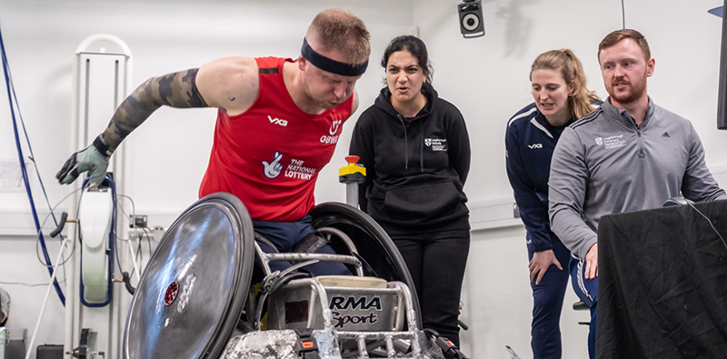 A wheelchair rugby athlete undergoing testing in a lab