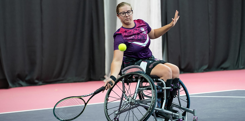 An athlete playing wheelchair tennis