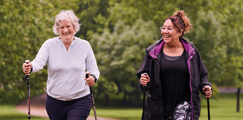 Two older ladies walking activity in a park