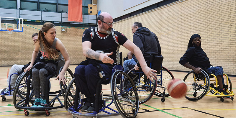 A group of people playing wheelchair basket ball