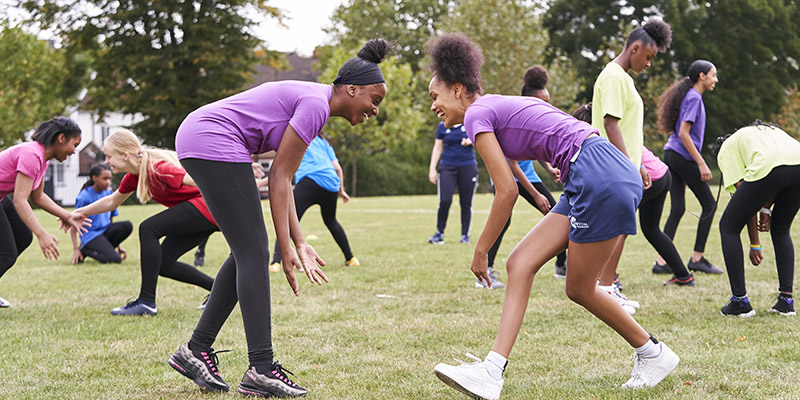 two young girls play sports