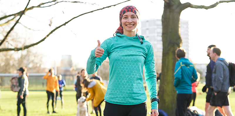 A female runner giving a thumbs up