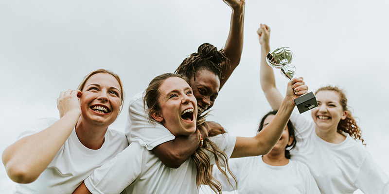 Female football players celebrating their victory