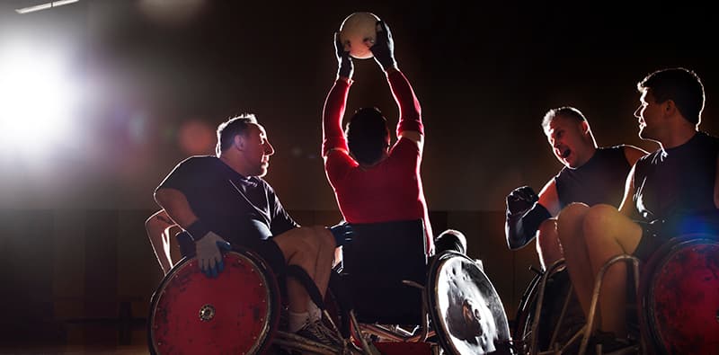 Group of people playing wheelchair rugby